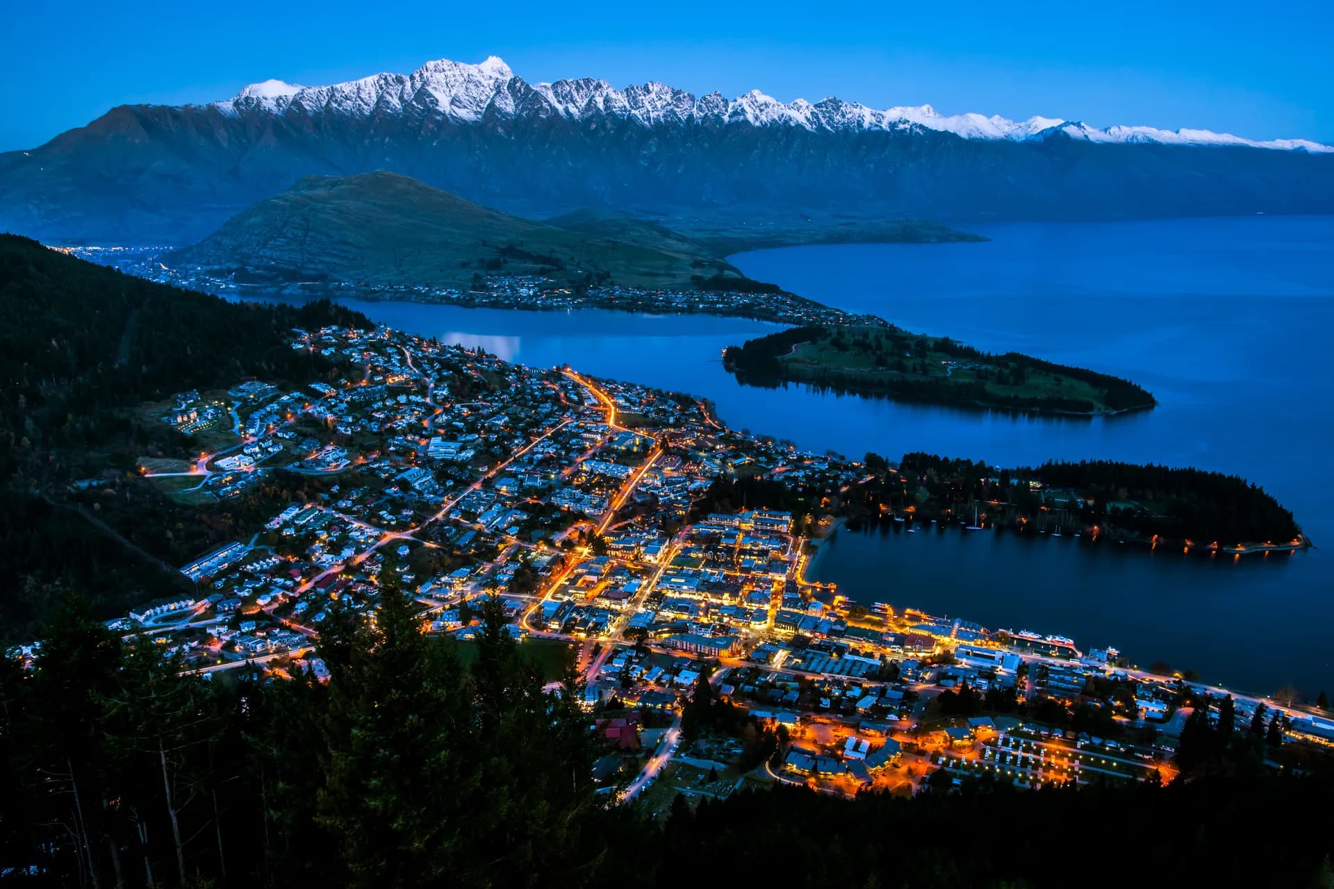 Aerial view of Queenstown at night with Remarkables and Lake Wakatipu